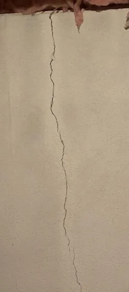 Vertical Poured concrete wall crack in basement Vertical Poured concrete wall crack in basement